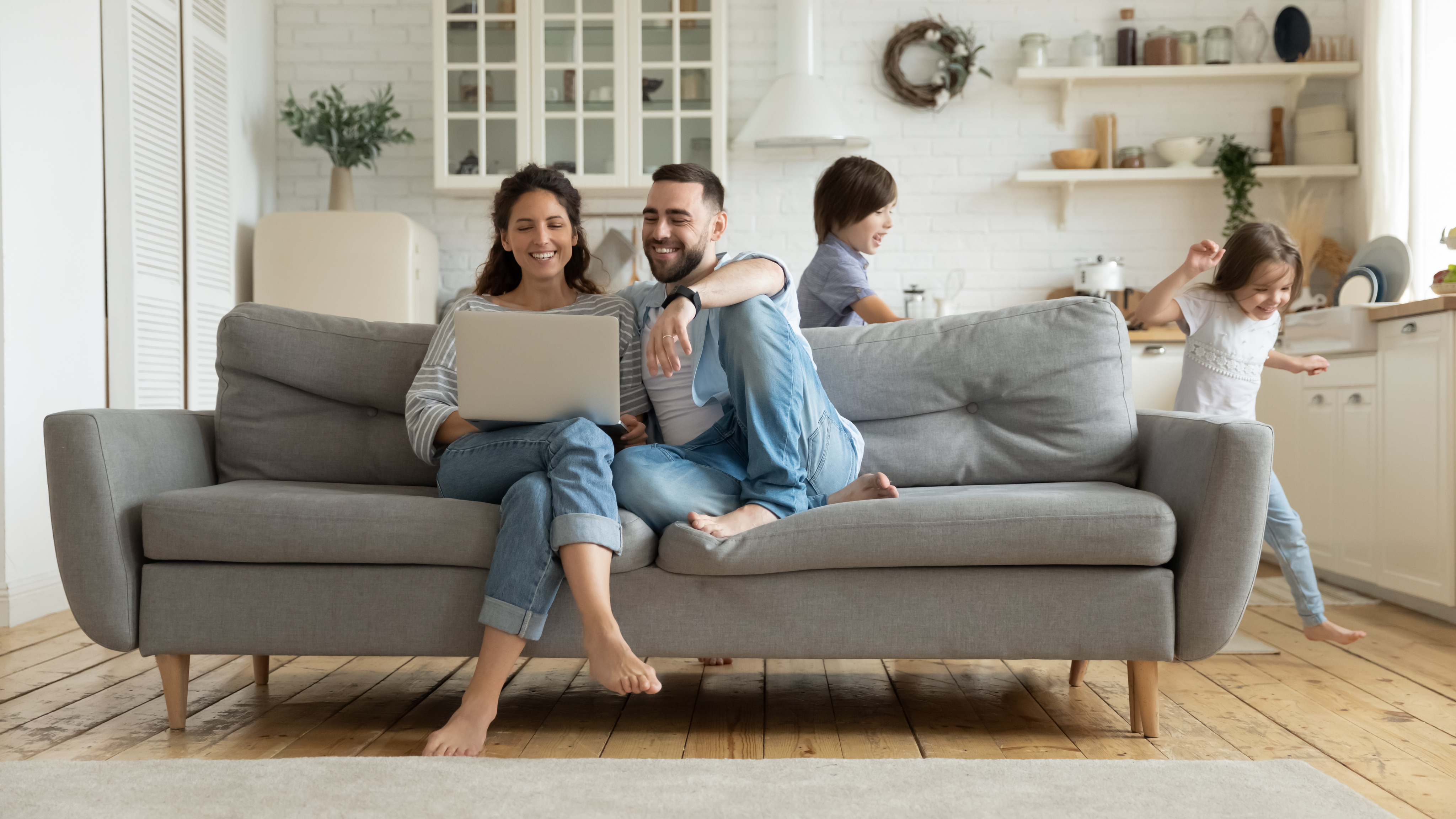 A happy family relaxes, celebrating as they lock in a lower mortgage rate with Amerisave's Lock and Shop program
